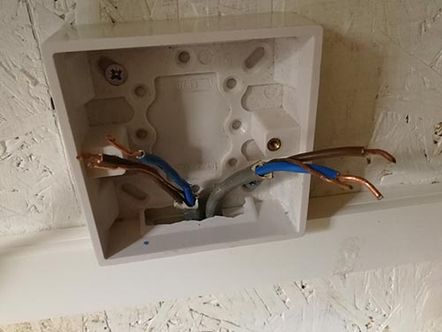 Running cables into back box ready for connecting up