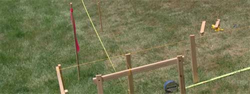 Stakes knocked in to mark fence post locations