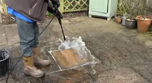 Power wash off patio cleaner using a power washer