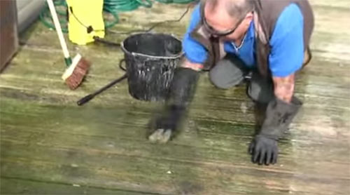 Scrub the pre-treatment into the decking to lift off lichen build-up