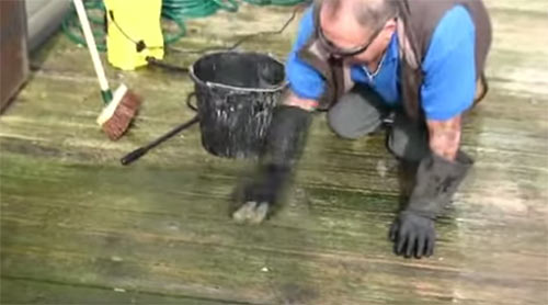 Scrub the pre-treatment into the decking to lift off lichen buildup