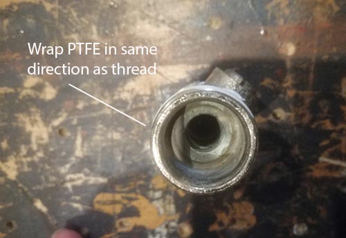 Wrap PTFE tape in the direction of the thread you are winding it around