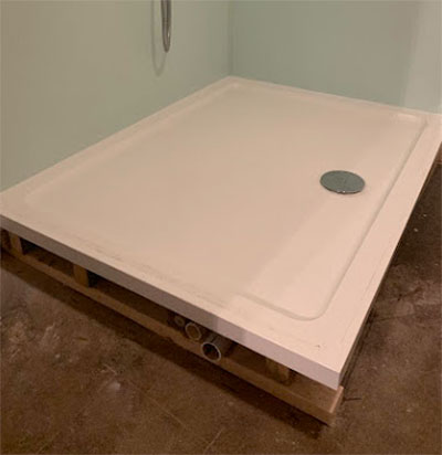 Shower tray secured in place