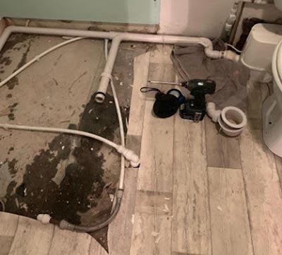 Existing raised shower tray removed