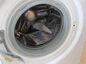 Inside of washing machine drum with manufacturers instructions