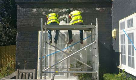 Spraying walls with Spraystone acrylic paint