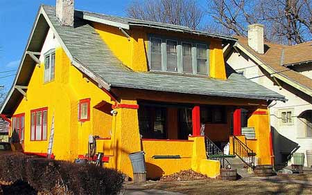 Bright yellow exterior finish on property