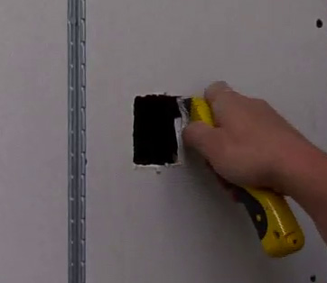 Squaring up plasterboard hole with hobby knife