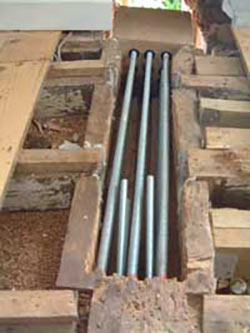 Reinforcing bars set into timber