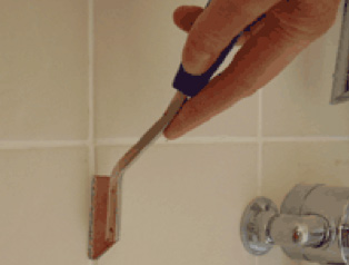 Scraping grout with a rake