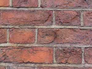 Brick wall with brick faces blown off