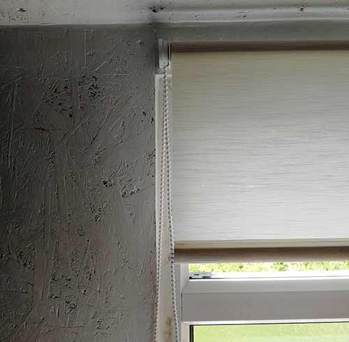 Roller blind covering window reveal