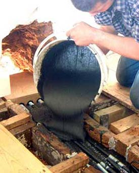 Pouring resin into slot in timber