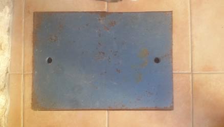 Metal plate covering floor safe