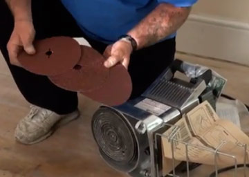 Using an edge sander on timber floorboards