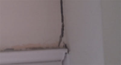 Settlement crack above door frame