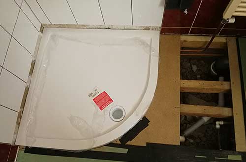 Shower tray fixed in place on floors