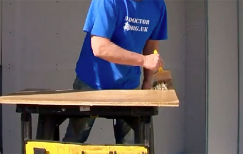 Wetting down spot board before placing plaster on it