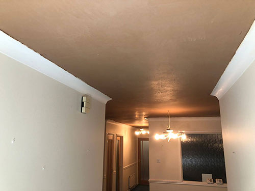 Skim coat plaster applied to ceiling