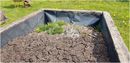 Add soil to raised bed