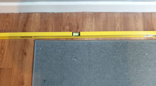 Check floor and ceiling levels using a spirit level