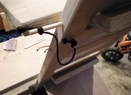 Timber pins secured to main body using lengths of string to prevent them getting lost