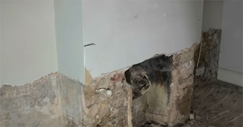 Remove all the old damp plaster using a small breaker