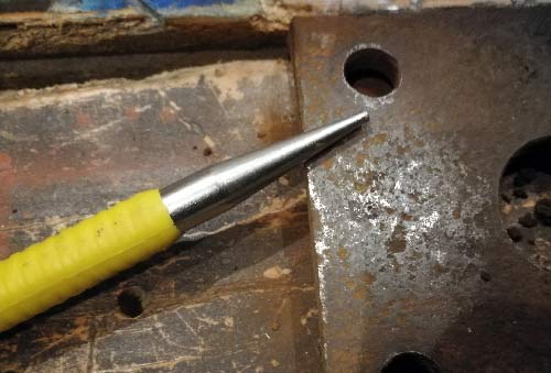 Centre punch used to ensure drill bit doesn't slip