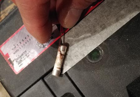 End of wire held on to end of fuse