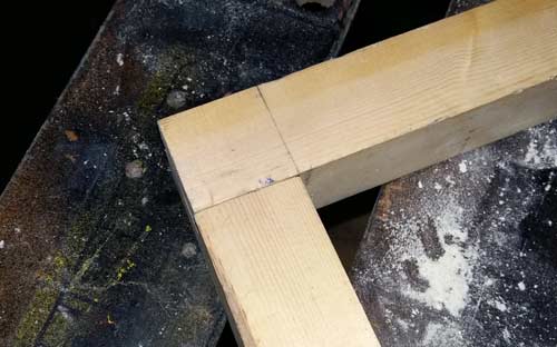 Trial fitting two timbers to create halving joint