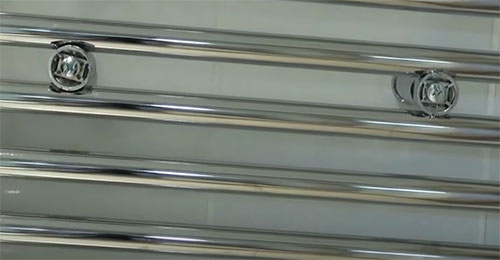 Towel radiator fixed to brackets