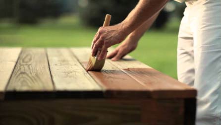 Applying wood stain with a brush