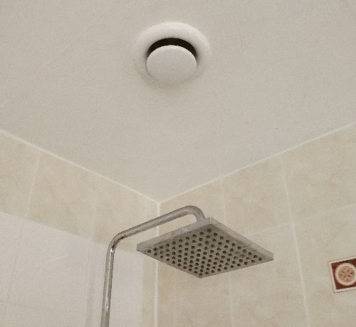 Inline extractor fan installed in zone 1 area above shower