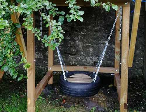 Tyre swing hung beneath playhouse