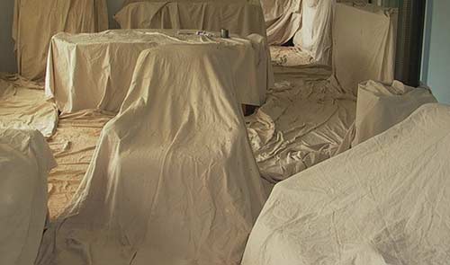 Furniture covered with dust sheets