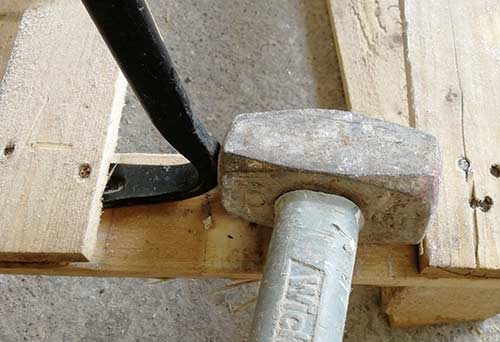 Knock claw under board with hammer
