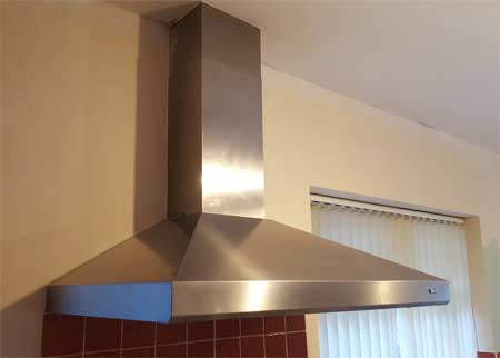 Cooker hood installed above hob