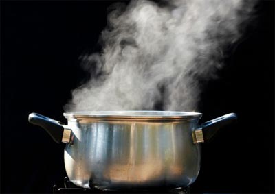 Hot pan on hob steaming