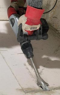 Concrete breaker breaking up concrete floor