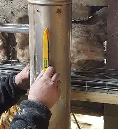 Flue being levelled using a spirit level