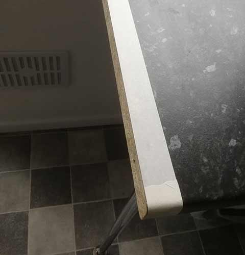 Apply masking tape to the worktop edge