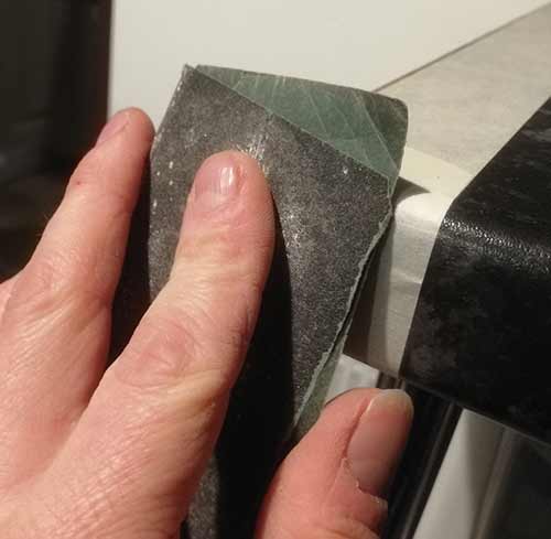 Use sandpaper to fine-tune the shape of your laminate worktop strip